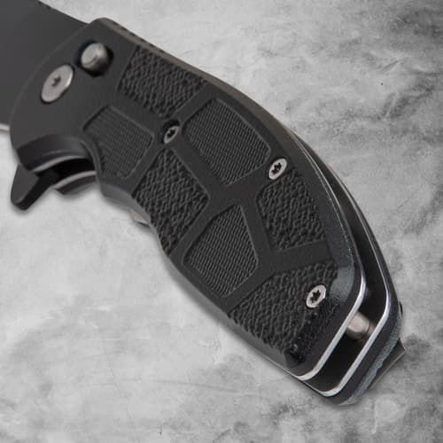 Close-up of black knife handle with textured grip