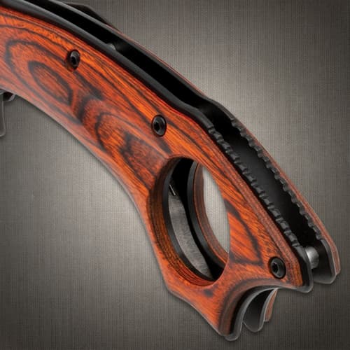 Close-up of the red wood handle with finger hole