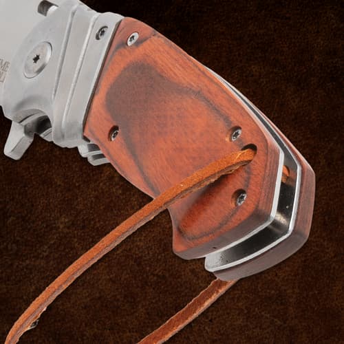 Close-up of Timber Wolf knife handle with leather strap