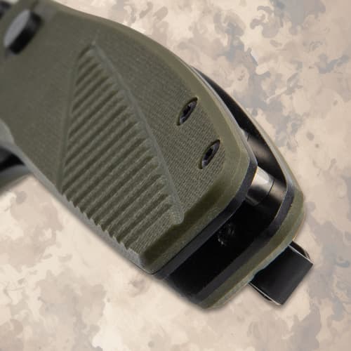Close-up of the textured green handle of a folding knife
