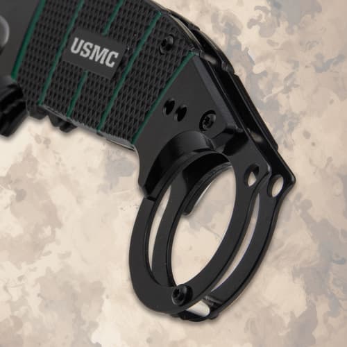 Close-up of USMC karambit knife handle and ring
