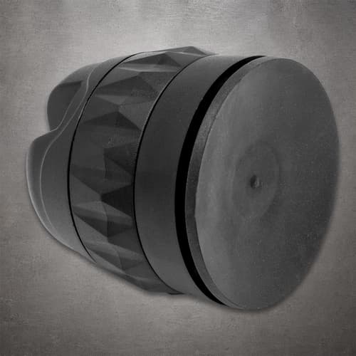 Max Edge knife sharpener lying on its side, showing its circular non-slip base and textured black body