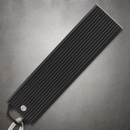 Black closed knife handle with ribbed texture and keyring