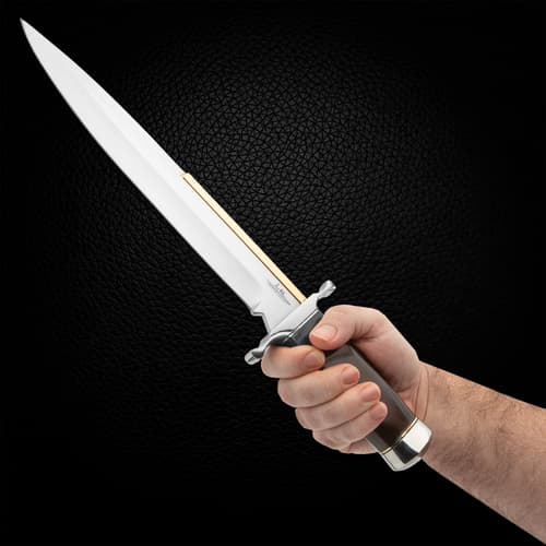 The knife, measuring 17 1/2” overall, has a stainless steel blade with oversized stainless guard and pommel.