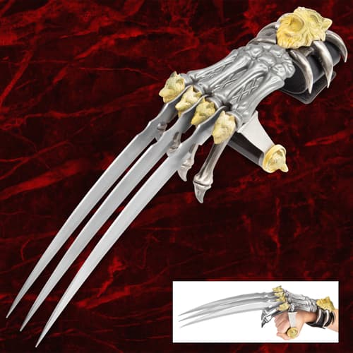 Metal claw weapon with wolf and lion designs on red background