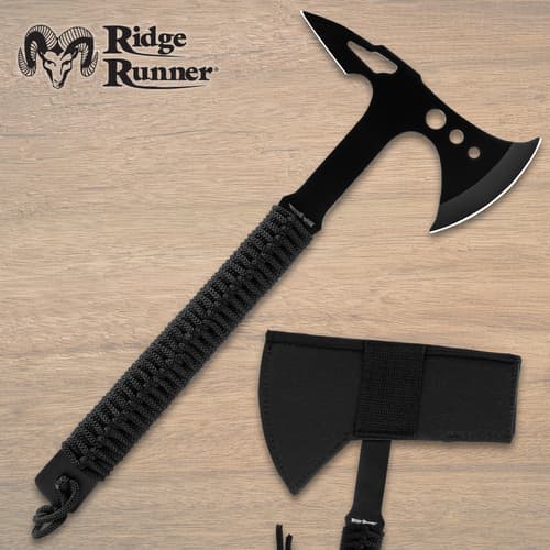 Black tomahawk with cord grip and sheath on wooden background