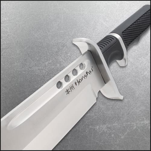 Close-up of knife blade with engraved text and black handle