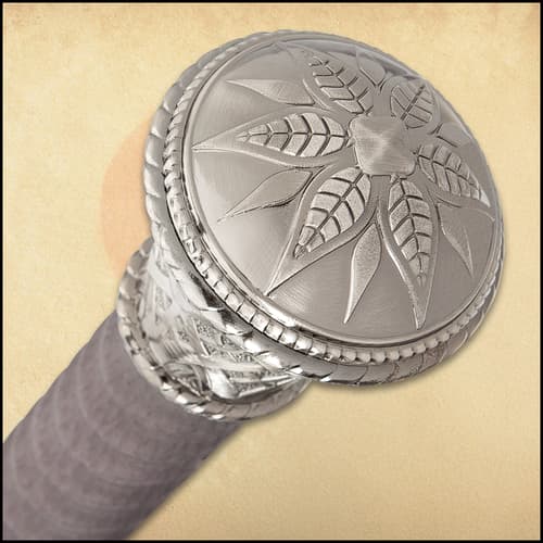 Detailed view of the Damascus steel blade and leather wrapped handle with the cane scabbard in the background.