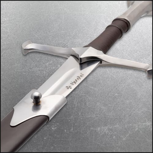 Close-up of sword hilt with brown grip and crossguard