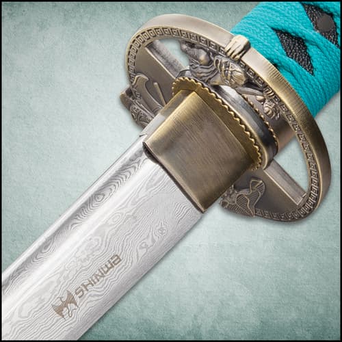 The black hardwood scabbard has teal hanging cord that matches the cord wrapped around the katana handle.