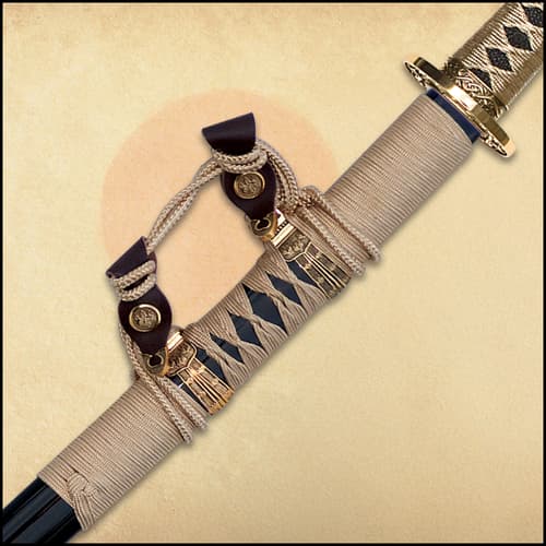 Detailed view of both the Damascus steel blade of the sword and the brass guard and pommel of the handle.