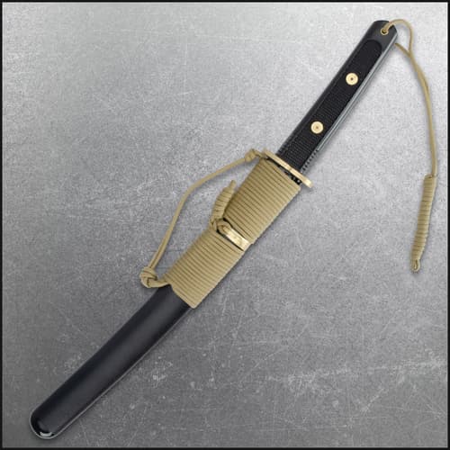 Tanto in scabbard with paracord wrap, black handle, and gold accents
