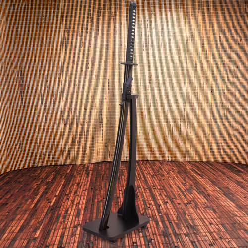 Sword on black stand against bamboo wall and wooden floor