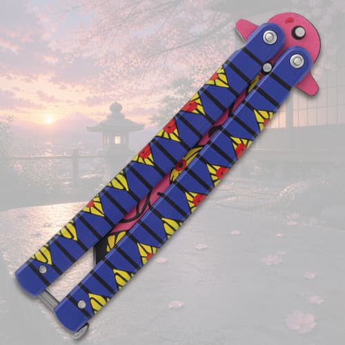 Closed butterfly knife with vibrant pattern, sunset scene