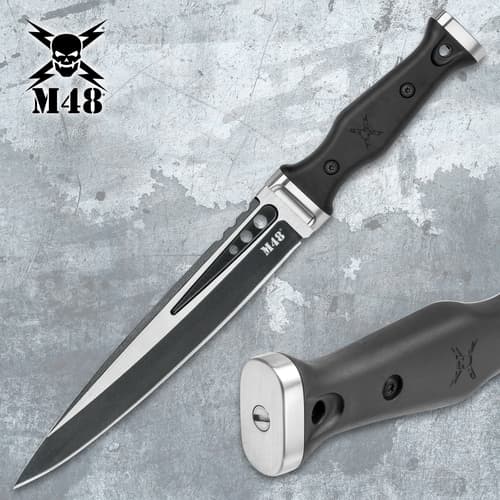 M48 tactical knife with black handle and sheath on a textured background
