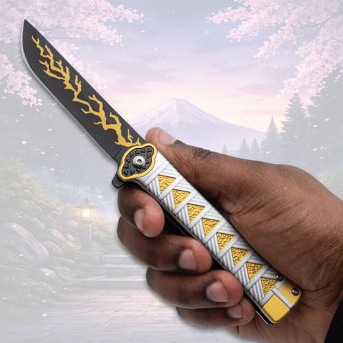 Hand holding knife with yellow lightning design