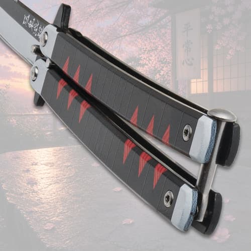 Close-up of butterfly knife handle with red accents, cherry blossom background