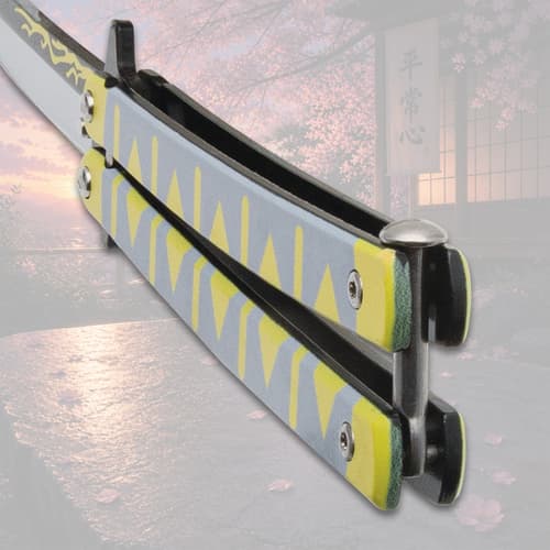 Close-up of butterfly knife handle with yellow pattern