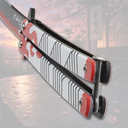 Close-up of butterfly knife handle with flame design