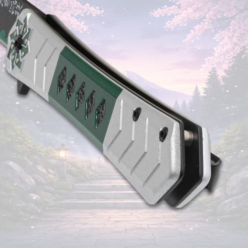 Close-up of knife handle with green and silver design