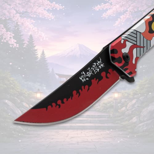 Close-up of knife blade with flame design, scenic background
