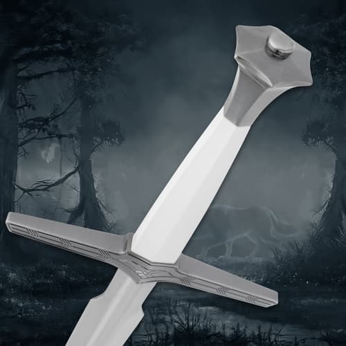 Sword handle close-up with detailed pommel, forest background