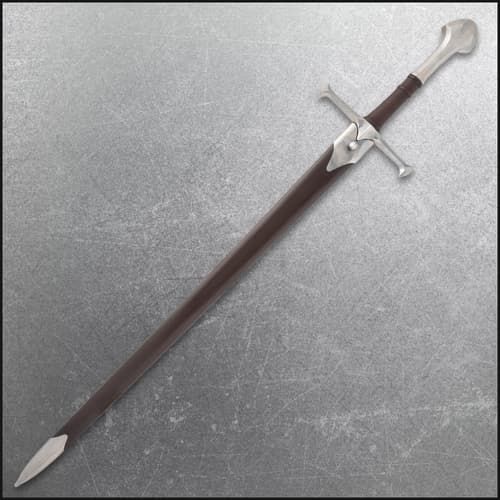 Sword sheathed in brown scabbard on textured surface