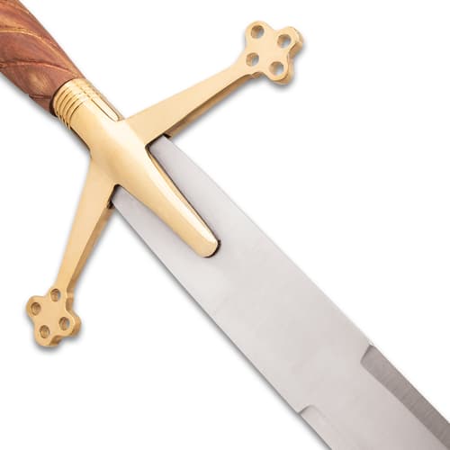 Close-up of a brass crossguard on a sword blade