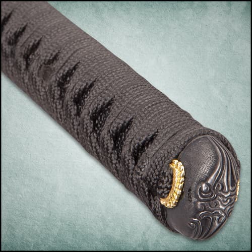 Black and gold notch on black lacquered scabbard with black hanging cord wrapped around it.