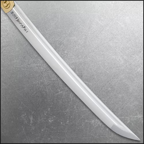 Close-up of tanto blade with engraved text on a textured background