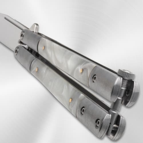 Close-up of butterfly knife handle with pearl pattern