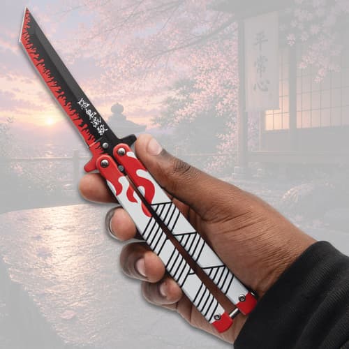 Hand holding a butterfly knife with flame design