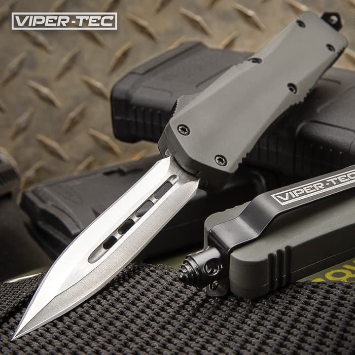The Mini Ghost Series Grey Double Edge OTF Knife has a 2 3/4" stainless steel blade and tough black handle, shown on tactical background.