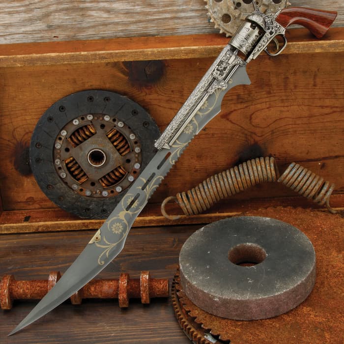 Otherworld Steampunk Gun Blade Sword shown with gun handle and ornate blade next to mechanical pieces and wood. 