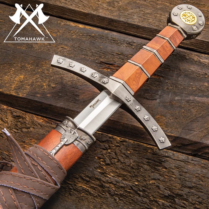 Tomahawk medieval broad sword has a composite brown handle with decorative cross guard and pommel. 