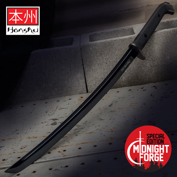 Special edition Black Honshu Boshin wakizashi 1060 high carbon steel blade with black TPR handle on to of cement blocks
