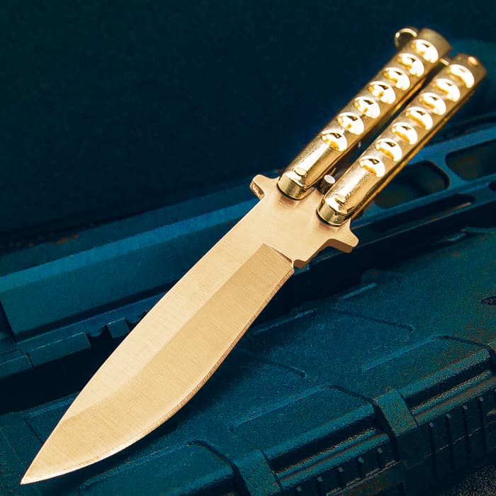 The Gold Gyro Butterfly Knife has a stainless steel blade and skeletonize steel handle with high-polish gold finish.