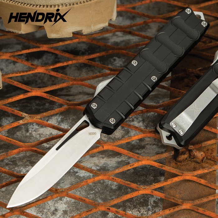Hendrix Triton Drop Point OTF Knife has a 3 1/2" M390 premium steel drop point blade with satin finish and grippy T6 aluminum handle.