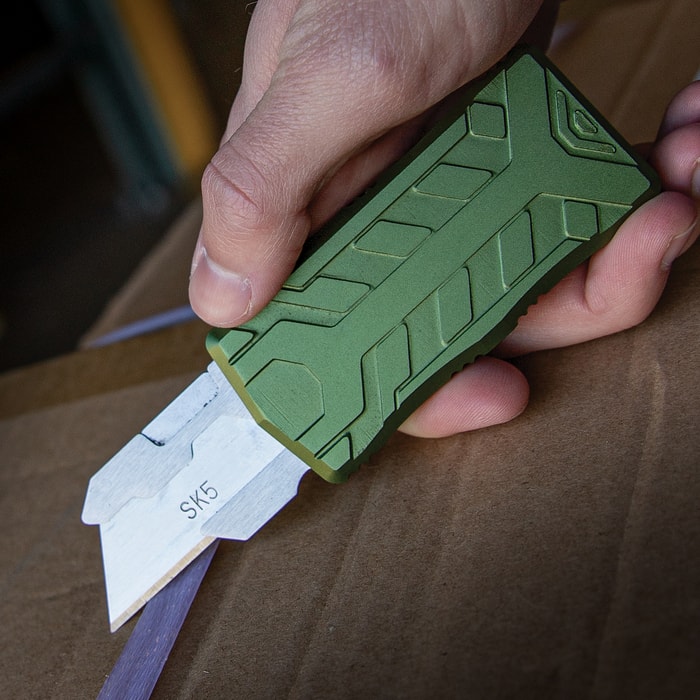 The TacKnives Fatboy OTF Box Cutter Knife shown in hand