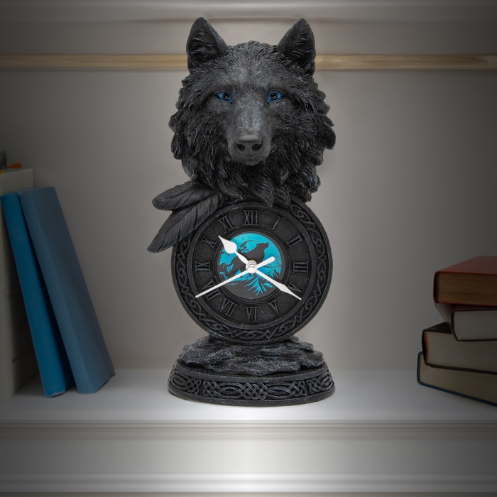 This black wolf desk clock is made of cast polyresin and hand painted to show a black wolf with blue eyes and Indian feathers. The face of the clock features blue artwork of a wolf howling.