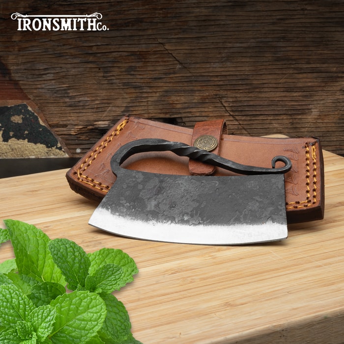 Full image of the Ironsmith Co Ulu Knife leaning on the included brown leather sheath.