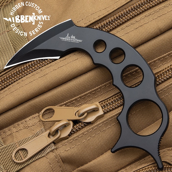 Gil Hibben Claw II Black Karambit is made of black coated stainless steel with thumb grips shown on a tactical background.