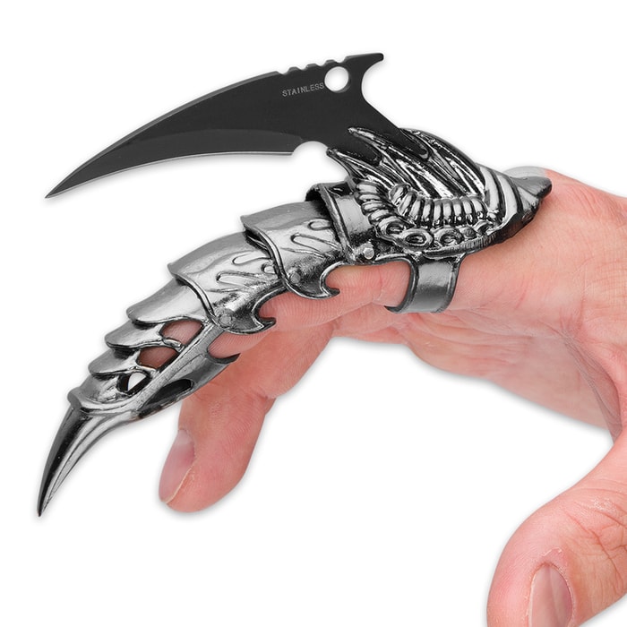 Iron Reaver Claw Knife with 2 1/4" blade shown on the index finger of a hand.