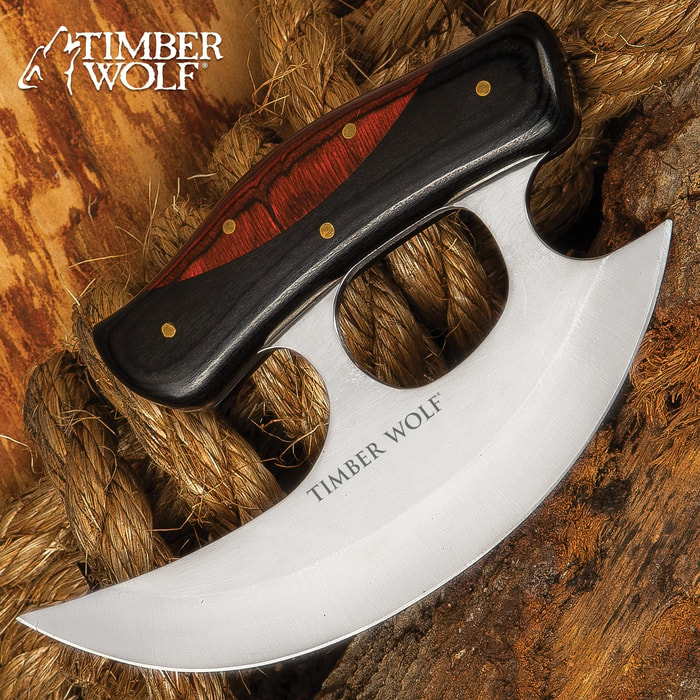 The Slicer Ulu Knife from Timber Wolf has a razor-sharp, curved 7” stainless steel reaper-style blade perfect for slicing and chopping tasks in the kitchen or at the camp