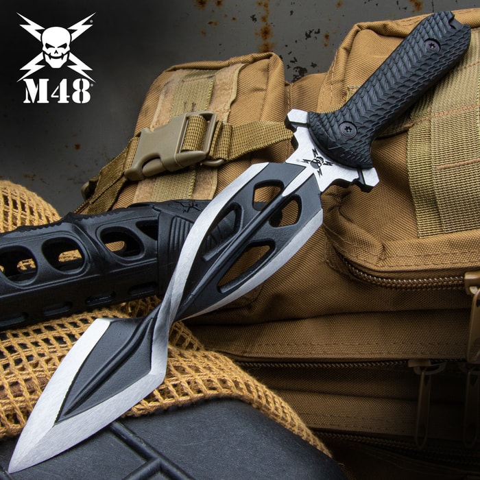 The M48 Tsunami Dagger has a twisted two-tone satin blade with custom sheath, shown on a tactical background.