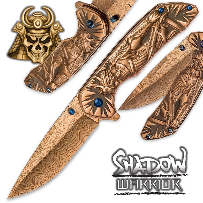 The Shadow Warrior Assisted Opening Knife has an ornate gold colored handle and 3 1/2” DamascTec steel blade.