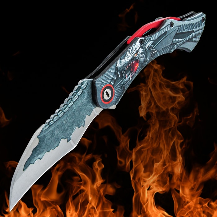 Angled image of Red Ridgeback Dragon Pocket Knife with an orange flame in the background.
