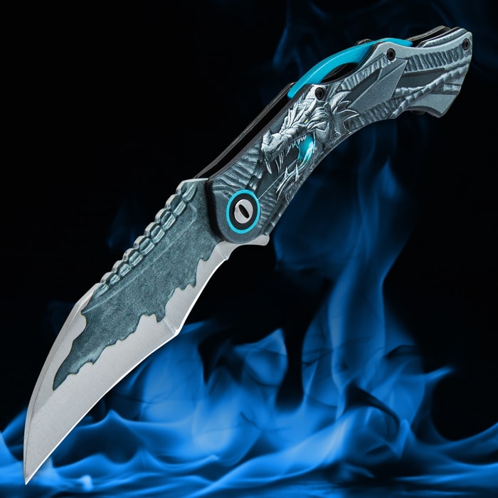 Angled image of Blue Ridgeback Dragon Pocket Knife with a blue flame in the background.