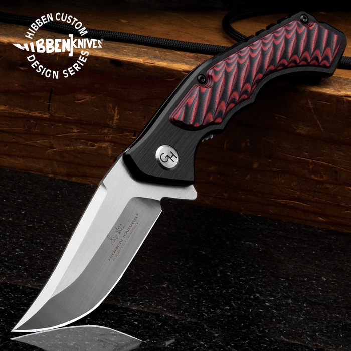 Hibben Red Whirlwind Pocket Knife shown opened with 7Cr17 stainless steel blade and black aluminum handle with red and black G10 inserts.