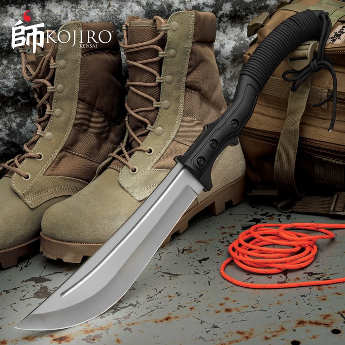 The Kojiro Naginata Sword with 440 stainless steel blade and curved TPU handle is shown next to a pair of boots.